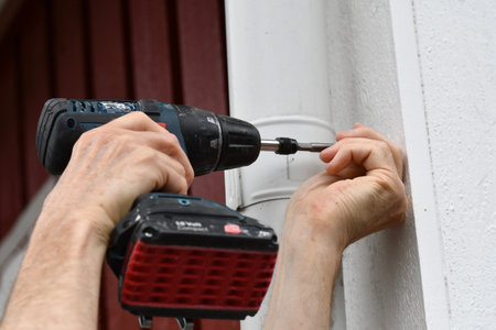 A man using a screwdriver machine to improve the house