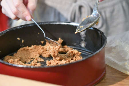 A woman making or baking a cake for a special occasionの写真素材