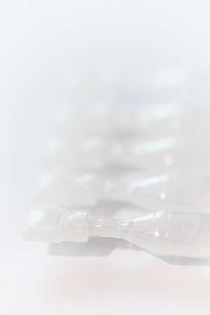 Photo of containers for eye drops on white backgroundの写真素材