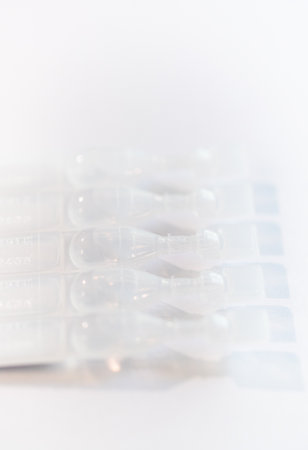 Photo of containers for eye drops on white backgroundの写真素材