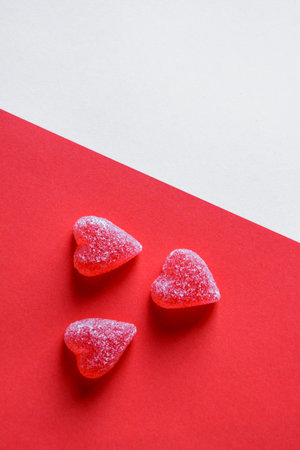Photo of red jelly candy hearts on red and white backgroundの写真素材