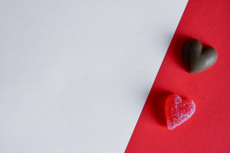 Photo of red jelly candy hearts on red and white backgroundの写真素材