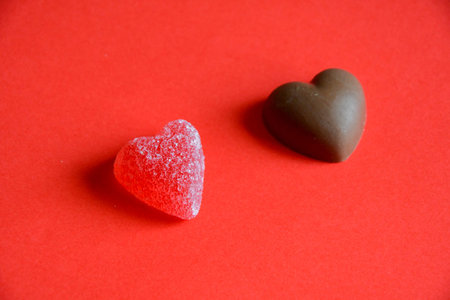 Photo of red jelly candy hearts on red background