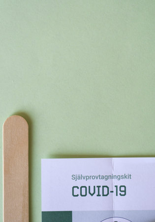 Overhead of covid and corona test on green backgroundの写真素材