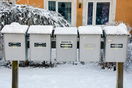 Post boxes in front of apartment houses in winter seasonの写真素材