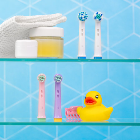Bathroom shelves with bath duck and different toothbrushesの写真素材