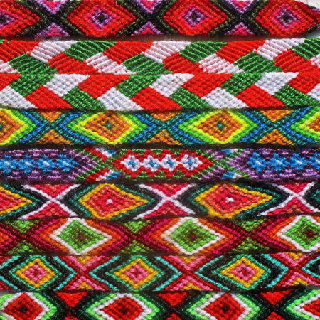 Patterns of color in a row of Native American woven bracelets.
