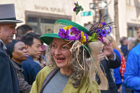 New York, New York: Woman wearing a green bonnet with purple flowers at the Fifth Avenue Easter Parade.のeditorial素材