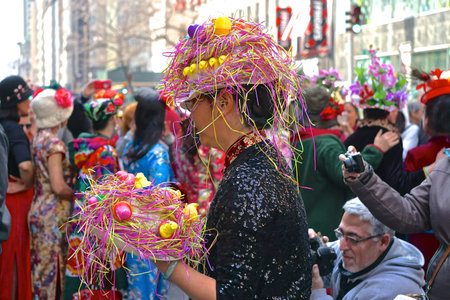 New York, New York: Asian woman wearing bonnet made with Peeps and eggs at the Fifth Avenue Easter...