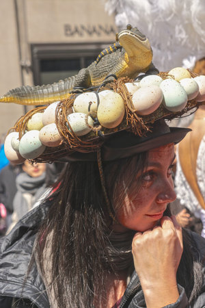 New York, New York: Woman wearing a bonnet featuring a lizard and its eggs at the Fifth Avenue...
