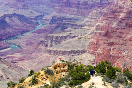 Grand Canyon National Park, Arizona: People taking pictures at the edge of the Grand Canyon, seen...
