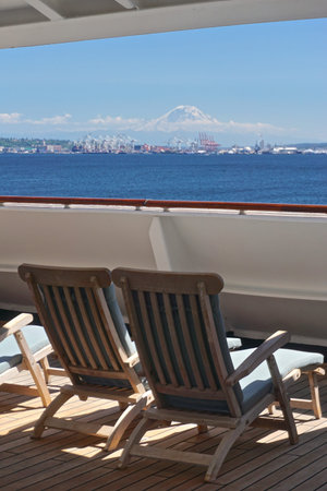 Seattle, Washington: Mt. Rainier seems to float in mid-air above Elliott Bay, as seen from the deck of a cruise ship heading out toward Alaska.の写真素材