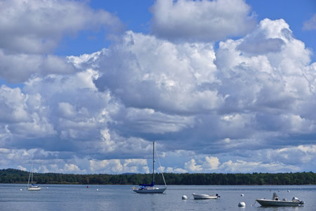Castine, Maine, USA: Small boats in the waters of Penobscot Bay, under a blue sky with dramatic...