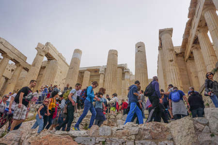 Athens, Greece: Tourists crowd the steps of the entrance to the Acropolis of Athens, under a hazy sky caused by dust pollution.のeditorial素材