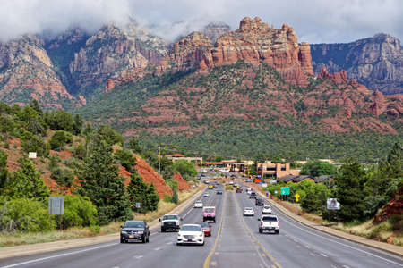Sedona, Arizona: View of Sedona with clouds hovering over the red rocks in the background.のeditorial素材