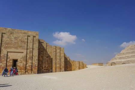 Saqqara, Egypt: Entrance to the funerary complex of Djoser (left) and the step pyramid (right).のeditorial素材