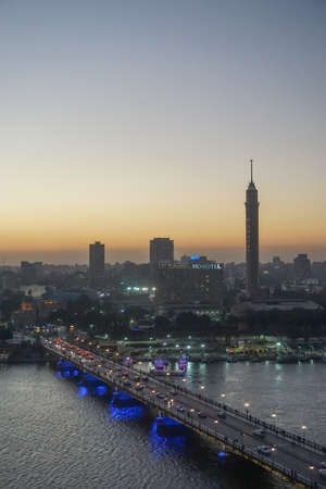 Cairo, Egypt: Cairo Tower and the Qasr el Nile Bridge at sunset. On Gezira Island in the River Nile, the tower is the tallest structure in Egypt.のeditorial素材