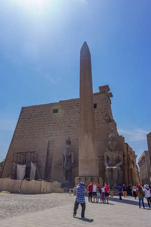 Luxor, Egypt: Groups of tourists at the entrance to the first pylon of Luxor Temple, built in 1400 BC on the east bank of the Nile River.のeditorial素材