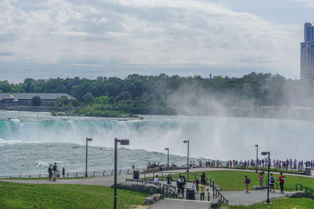 Niagara Falls, NY: Tourists view the Horseshoe Falls from Prospect Point, on the American side of the Niagara Gorge, across from Table Rock in Canada.のeditorial素材