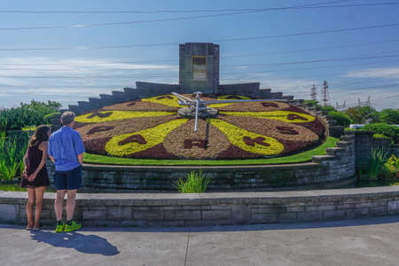 Queenston, Ontario, Canada: A couple views the Niagara Parks Floral Clock. The floral design is changed twice each year.のeditorial素材
