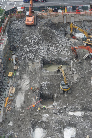 New York, New York: Workers encounter water in holes cut into the Manhattan schist bedrock as...