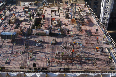 New York, New York: Men and materials during the construction of a 42-story high-rise apartment...
