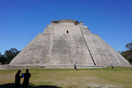Uxmal, Mexico: Tourists visit the Mayan Pyramid of the Magician, also known as The Pyramid of the Dwarf, 600-900 A.D.のeditorial素材