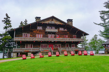 Sagamore Lake, NY: A row of Adirondacks chairs on the lawn in front of the Main Lodge at the Great...