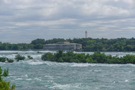 Niagara Falls, NY: The view from Prospect Point: The Niagara River, the former Toronto Power Generating Station, and Sky Screamer amusement park ride.のeditorial素材