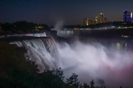 Niagara Falls, NY: The American Falls, the Horseshoe Falls (background), and hotels on the Canadian side of the gorge at night, from Prospect Point.の写真素材