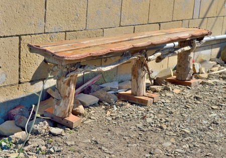 A wooden bench on old wall background.の写真素材