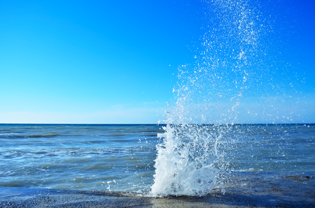 Powerful waves of the sea foam, breaking the concrete pierの写真素材