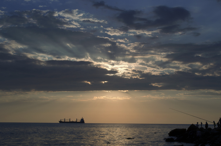 The ship that is laying a gas pipe on the sea bottom against the sunsetの写真素材
