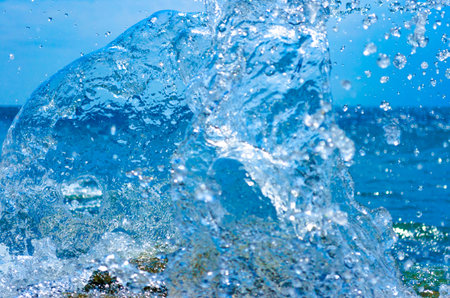 Coastal transparent sea/ocean crashing wave with foam on its topの写真素材