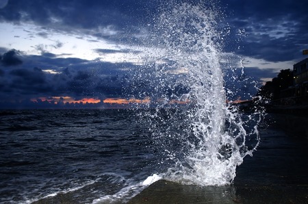 Splashing wave on the Black sea in the night.の写真素材