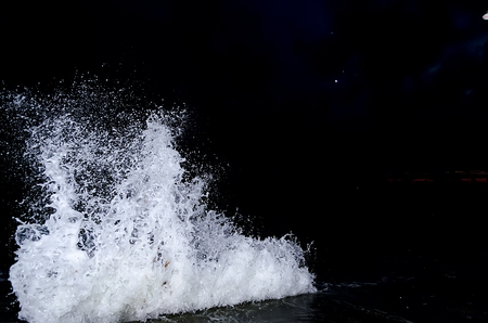 Splashing wave on the Black sea in the night.の写真素材