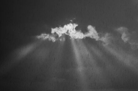 Rays of light in grey skyの写真素材