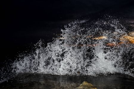 Splashing wave on the Black sea in the night.の写真素材