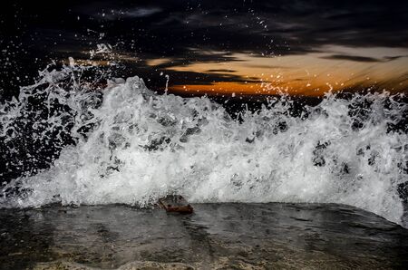 Splashing wave on the Black sea in the night.の写真素材