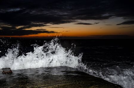 Splashing wave on the Black sea in the night.の写真素材