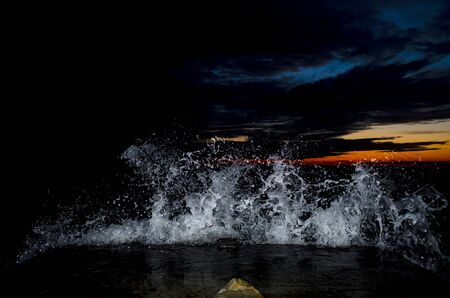 Splashing wave on the Black sea in the night.の写真素材