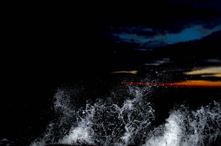 Splashing wave on the Black sea in the night.の写真素材