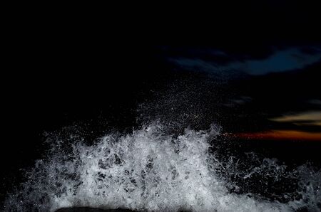 Splashing wave on the Black sea in the night.の写真素材