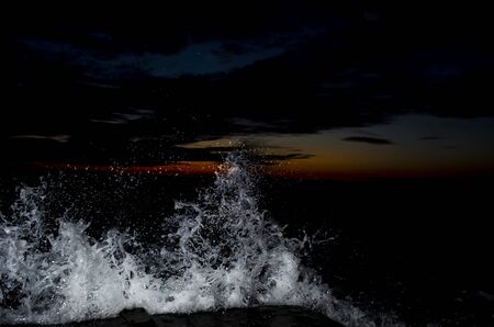 Splashing wave on the Black sea in the night.の写真素材