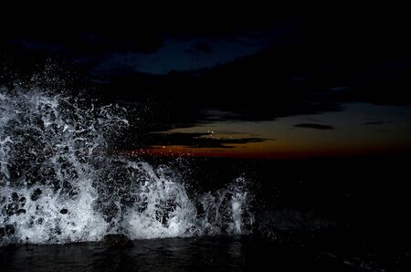 Splashing wave on the Black sea in the night.の写真素材