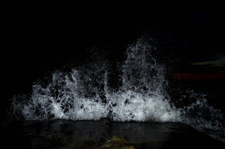 Splashing wave on the Black sea in the night.の写真素材