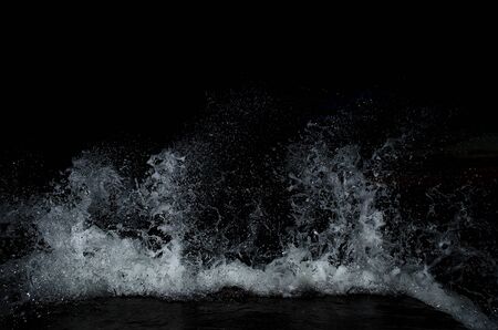 Splashing wave on the Black sea in the night.の写真素材