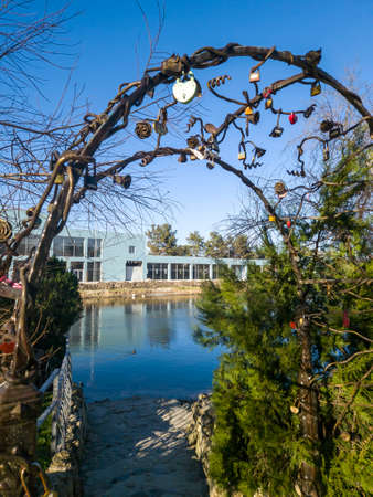 Wrought iron arch with wedding locks on the background of the river. Traditions to hang wedding locks on the bridge. Anapaの写真素材