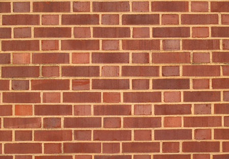 Old brick  exterior wall with Red and brown duo-sized bricks.   