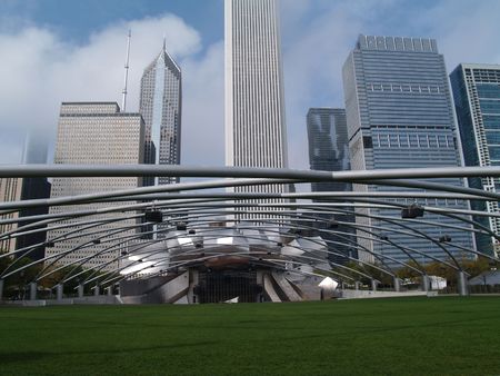 Grassy seating area of the Jay Pritzker Pavilion  showing the sound system supported on trellis style pipes in front of a Chicago skyline in Millennium Park.のeditorial素材
